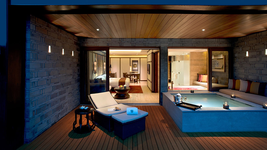 Terrace with lounge chairs and a lit plunge pool at Banyan Tree Chongqing Beibei, evening ambiance.