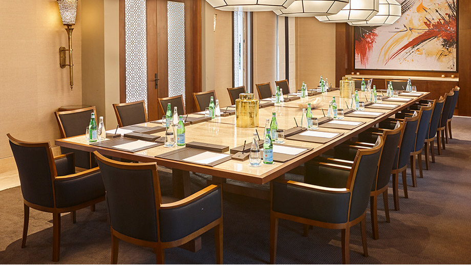 Meetings & events room setup with water bottles and notepads on a table at Banyan Tree Tamouda Bay.