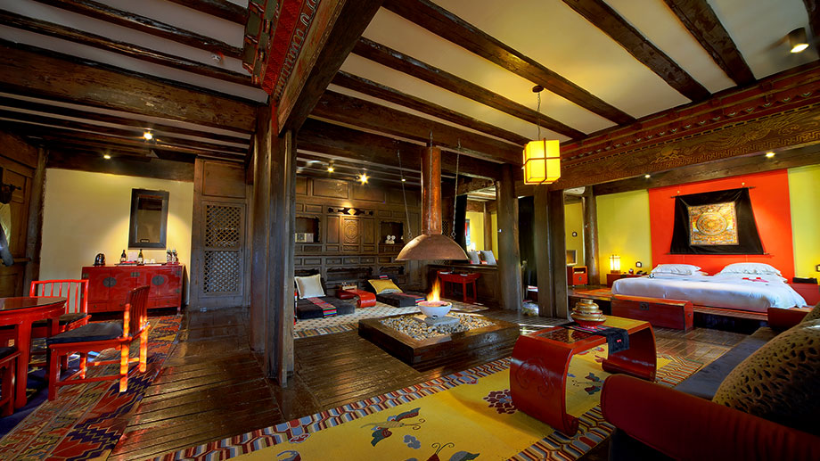 Luxurious suite with fireplace, vibrant decor at Banyan Tree Ringha, creating a cozy ambiance.